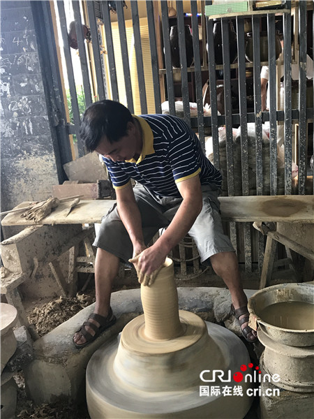 母先才在做陶藝