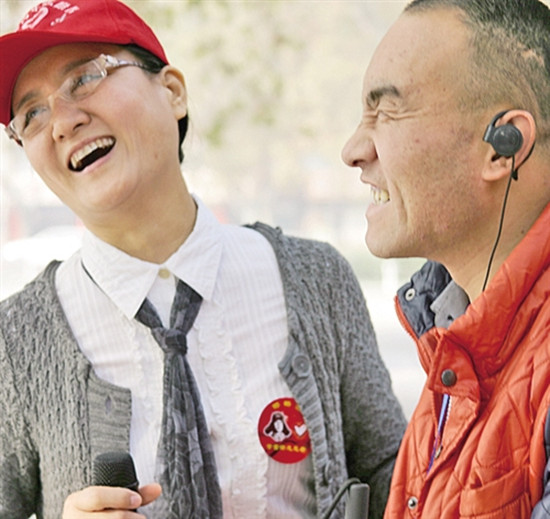 “天使之眼”志愿服務(wù)團(tuán)隊(duì)發(fā)起人孔媛媛（左）在為盲人朋友“講”電影。宋美倩/攝