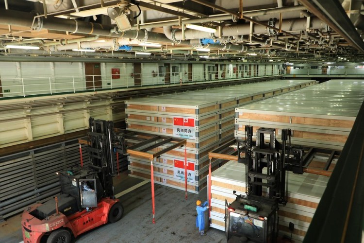 Relief supplies are transferred onto a ship waiting to depart for Tonga, in Guangzhou, south China's Guangdong Province, Jan. 30, 2022. (Photo by Xue Chengqing/Xinhua)