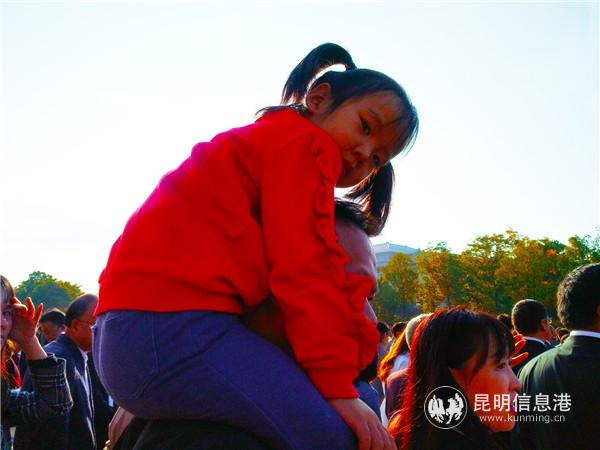 騎在父親肩膀上觀看升旗儀式的小朋友。記者江楓 攝