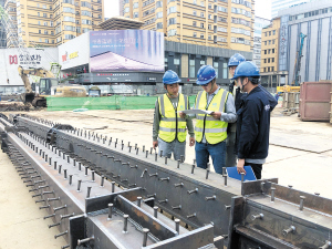 朱川東帶著幾個(gè)徒弟仔細(xì)檢查鋼立柱各項(xiàng)指標(biāo)是否合格。 記者黃曉松攝