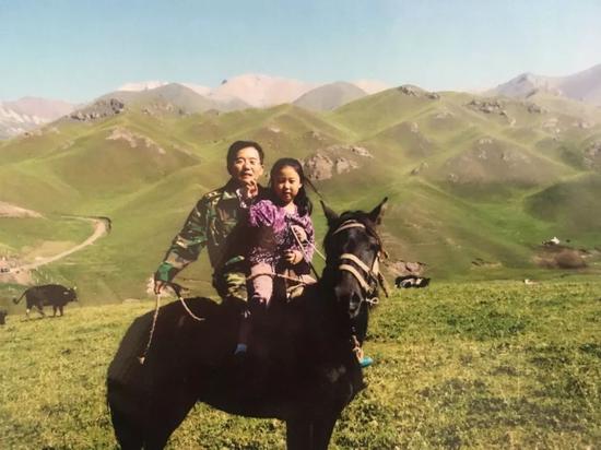 6歲的劉鄭伊與父親一起騎軍馬。