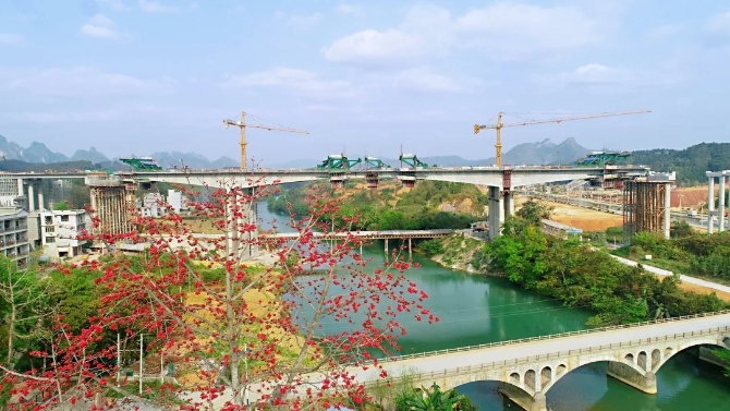 日前，廣西路橋集團(tuán)賀州至巴馬高速公路（都安至巴馬段）巴馬樞紐互通A匝道盤陽河2號橋中跨順利合龍，賀巴高速公路與河百高速公路的銜接互通實(shí)現(xiàn)對接。何再召 供圖.webp